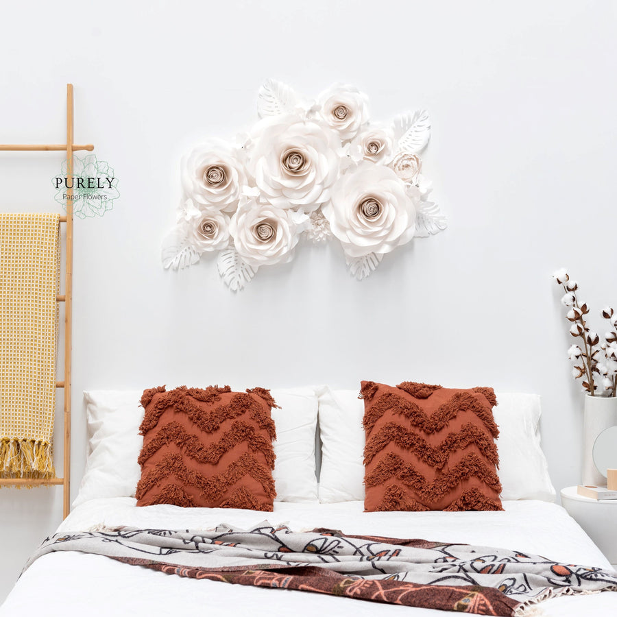 Large paper flowers backdrop of white roses above bed arranged on the wall